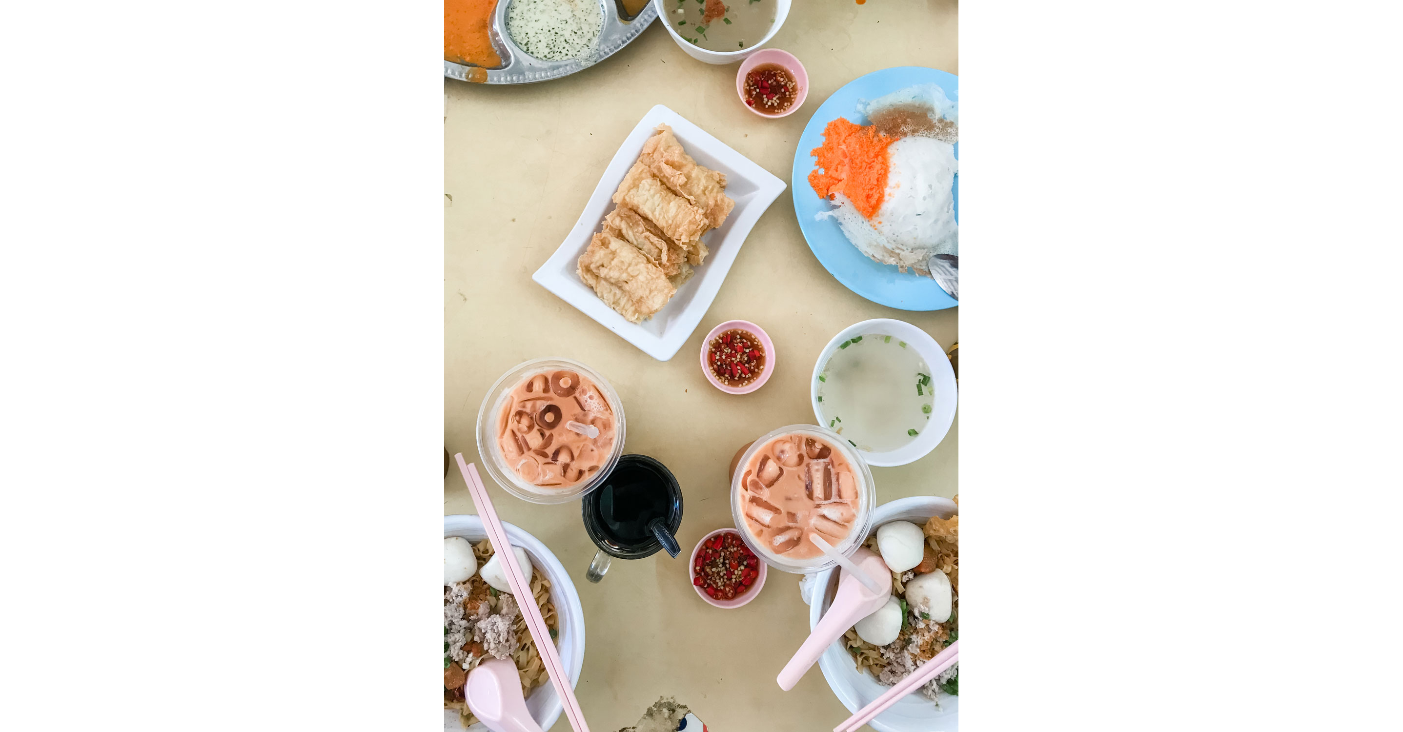 A table with drinks and different dishes.