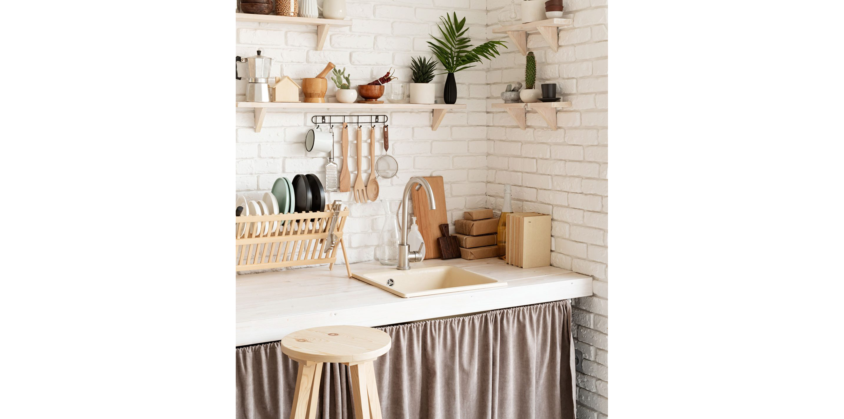 A kitchen countertop featuring wooden accessories.