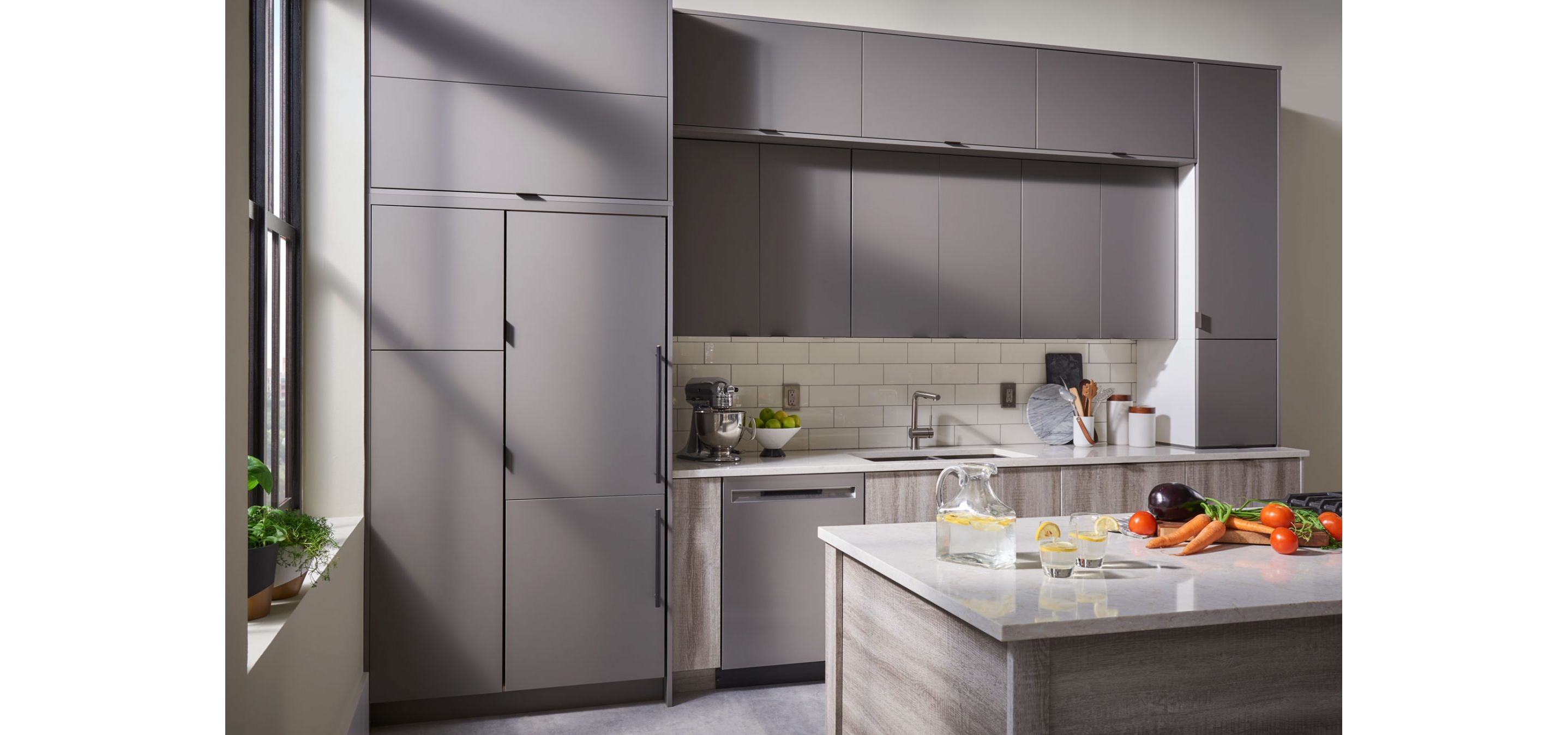 A gray kitchen with smooth finishes.