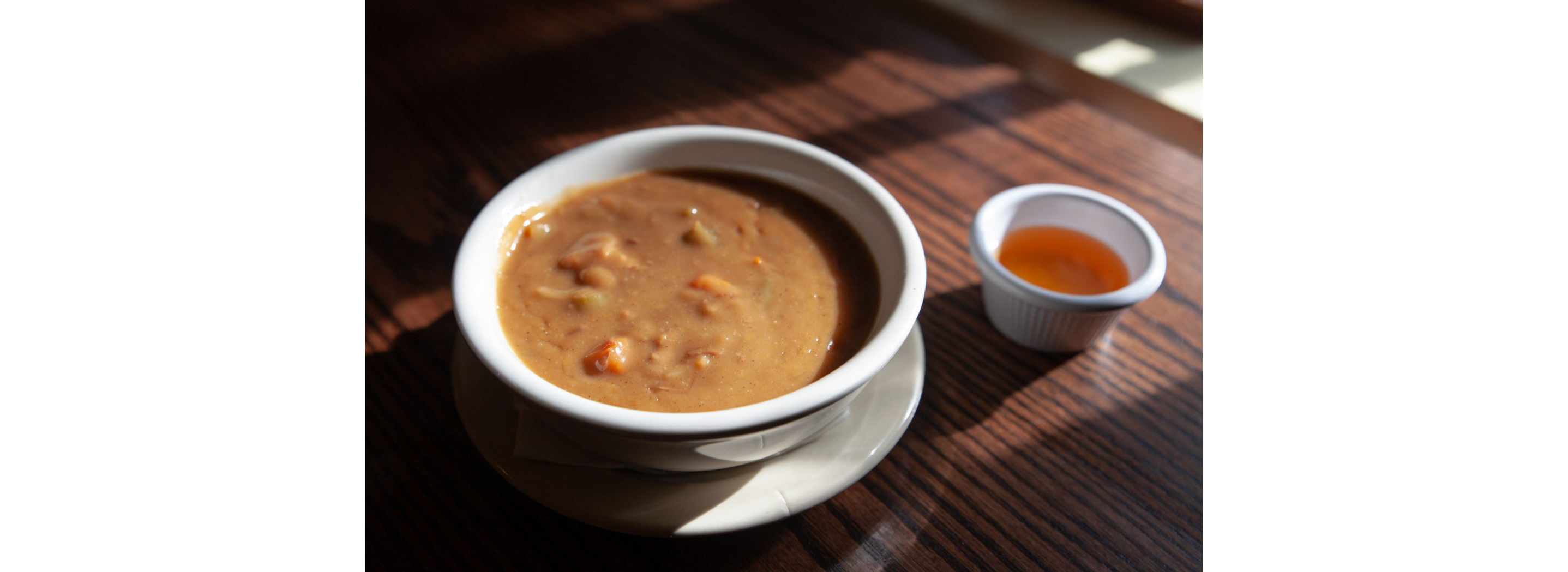 A small, white bowl of creamy snapper soup.