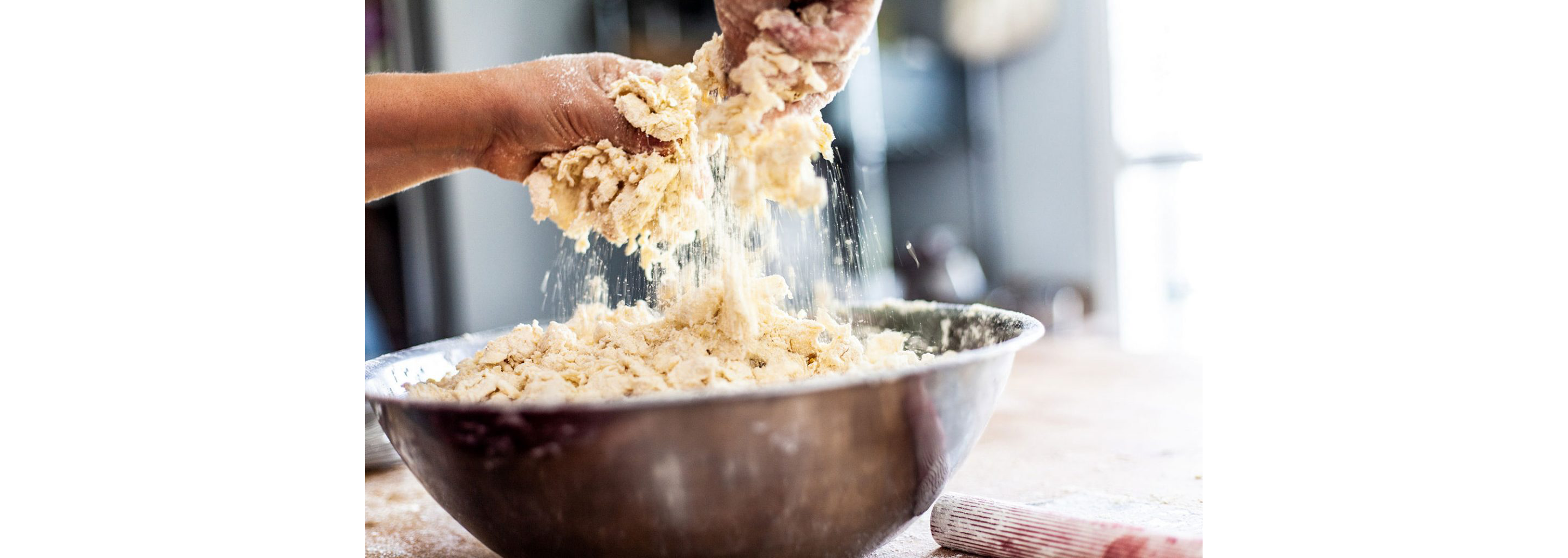 Working dough into a bowl.