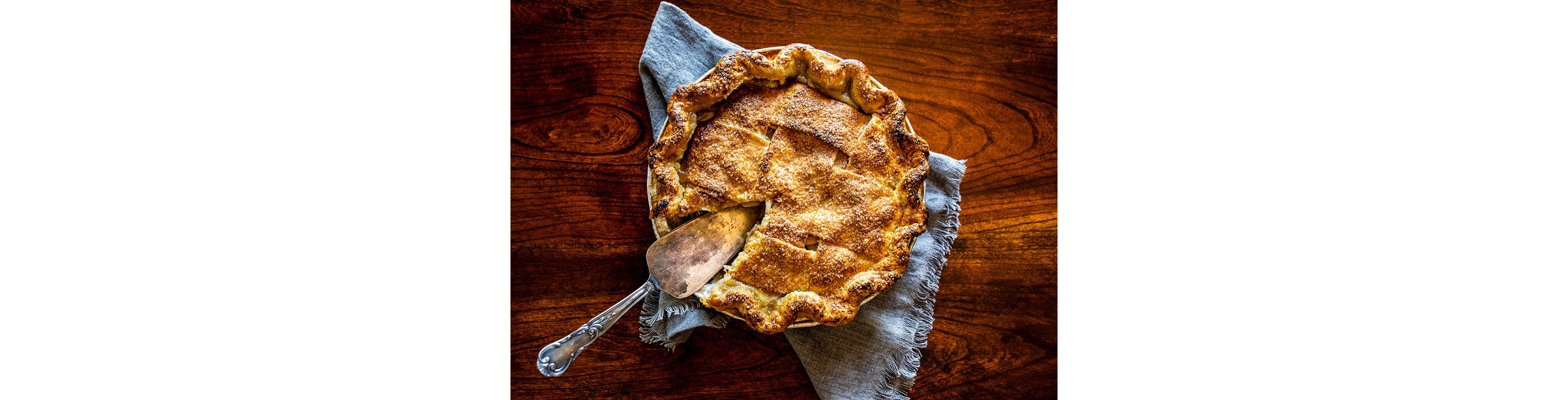 A pie with a serving spoon.