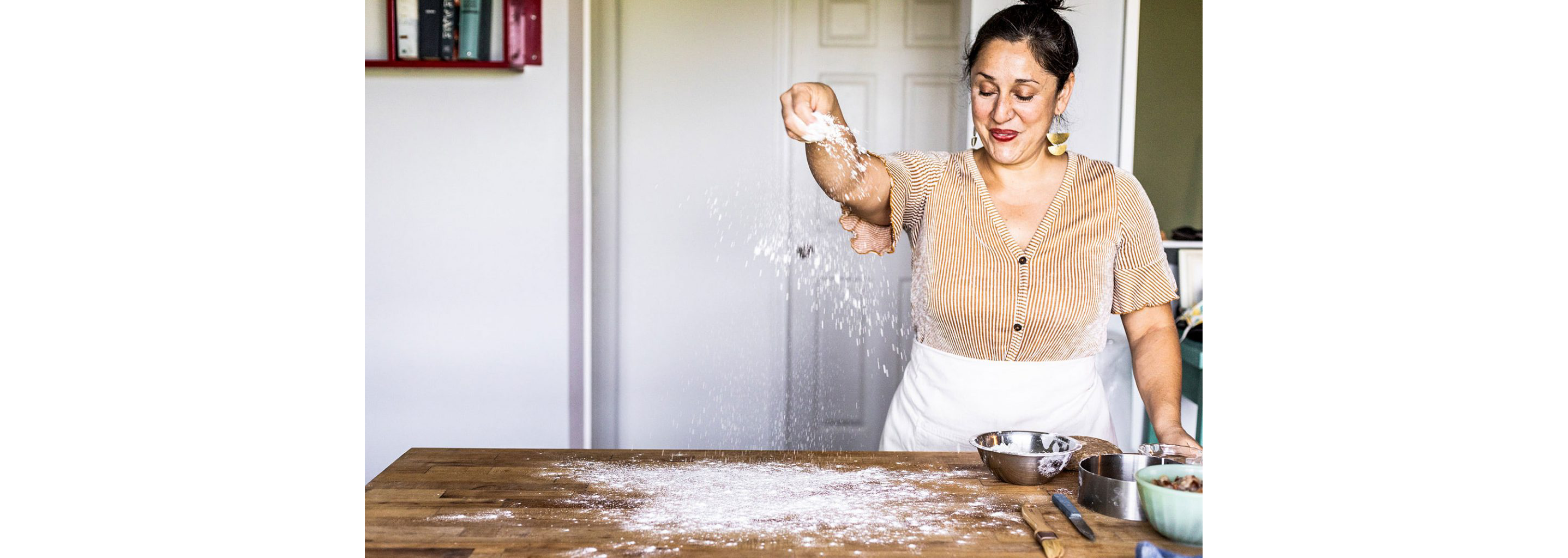 Spreading flour on a table.