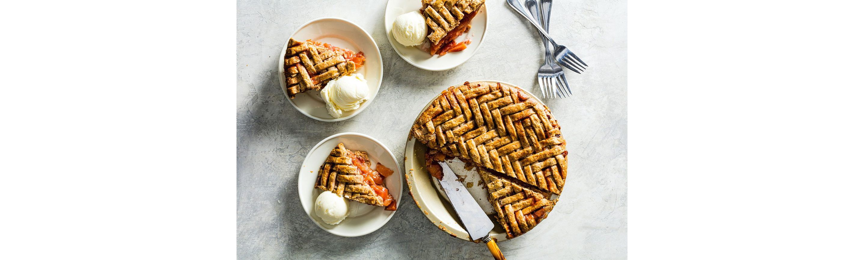Slices of pie and ice cream ready to be eaten.