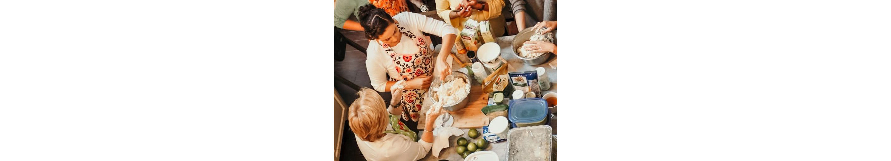 A family cooking together in a kitchen.