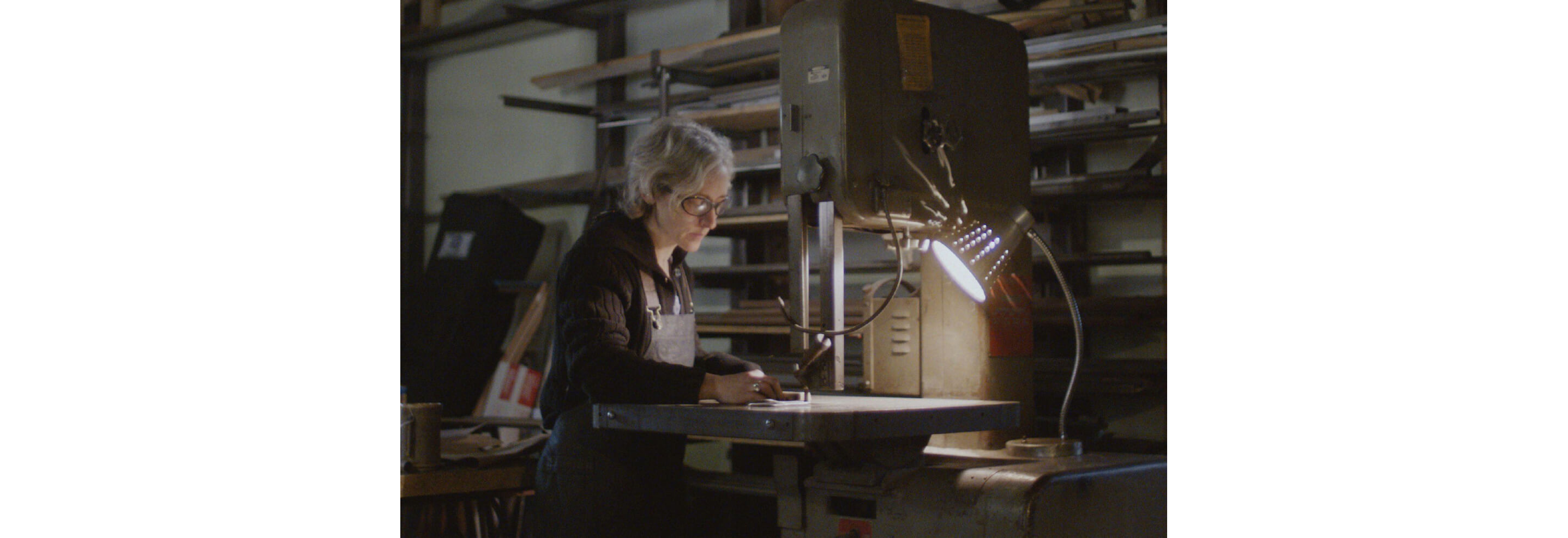 Erica focusing on her work in her shop.