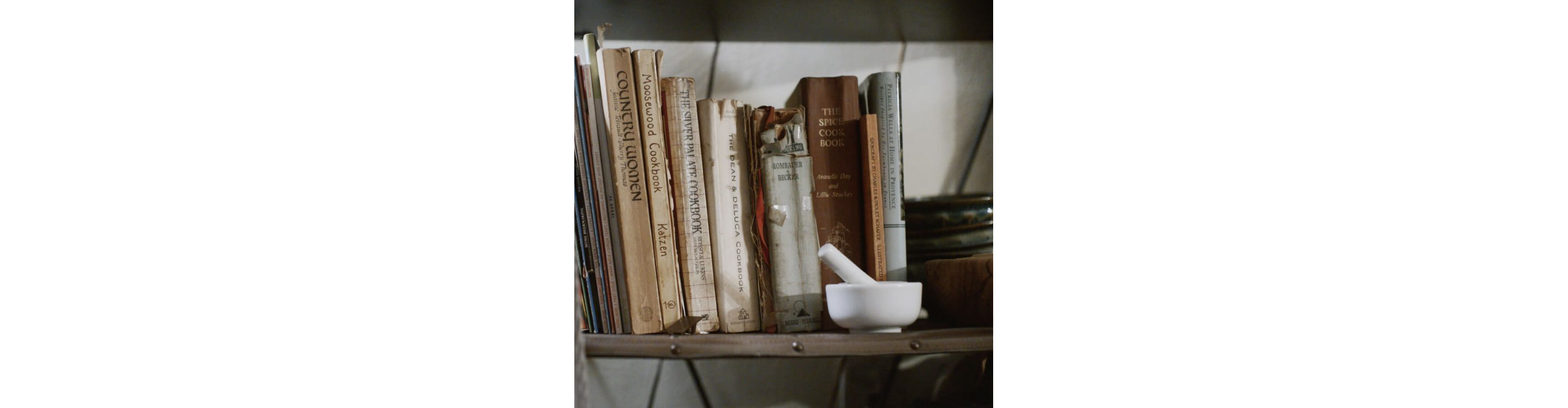 A shelf filled with Erica's avidly used cookbooks