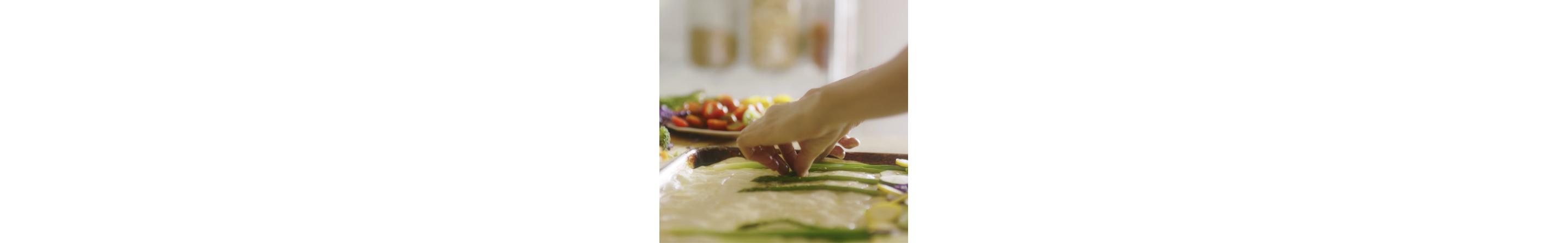 Loria Stern pressing vegetables into focaccia bread.