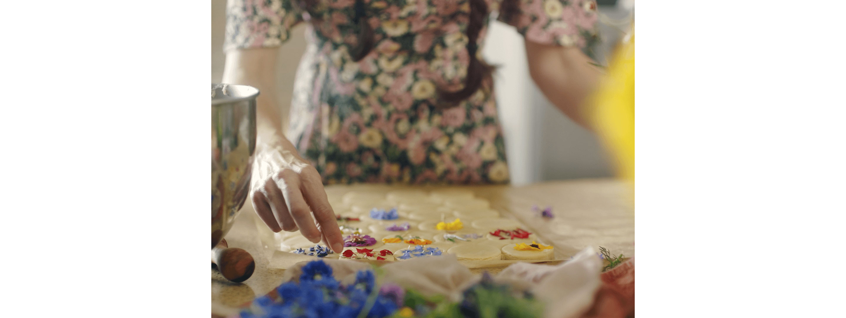 Loria Stern pressing edible flowers into cookies.