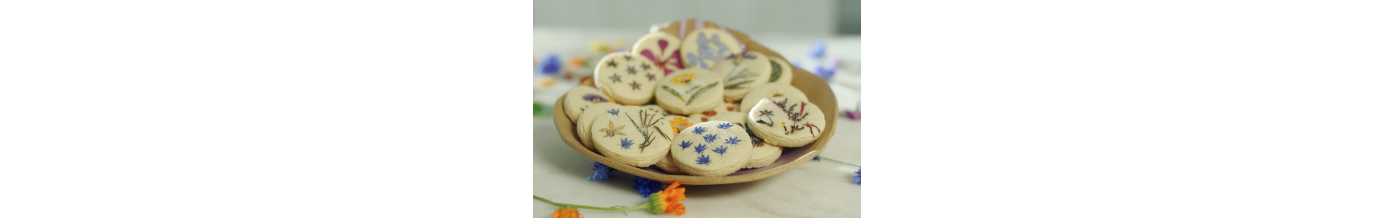 Freshly baked cookies with edible flowers pressed into them