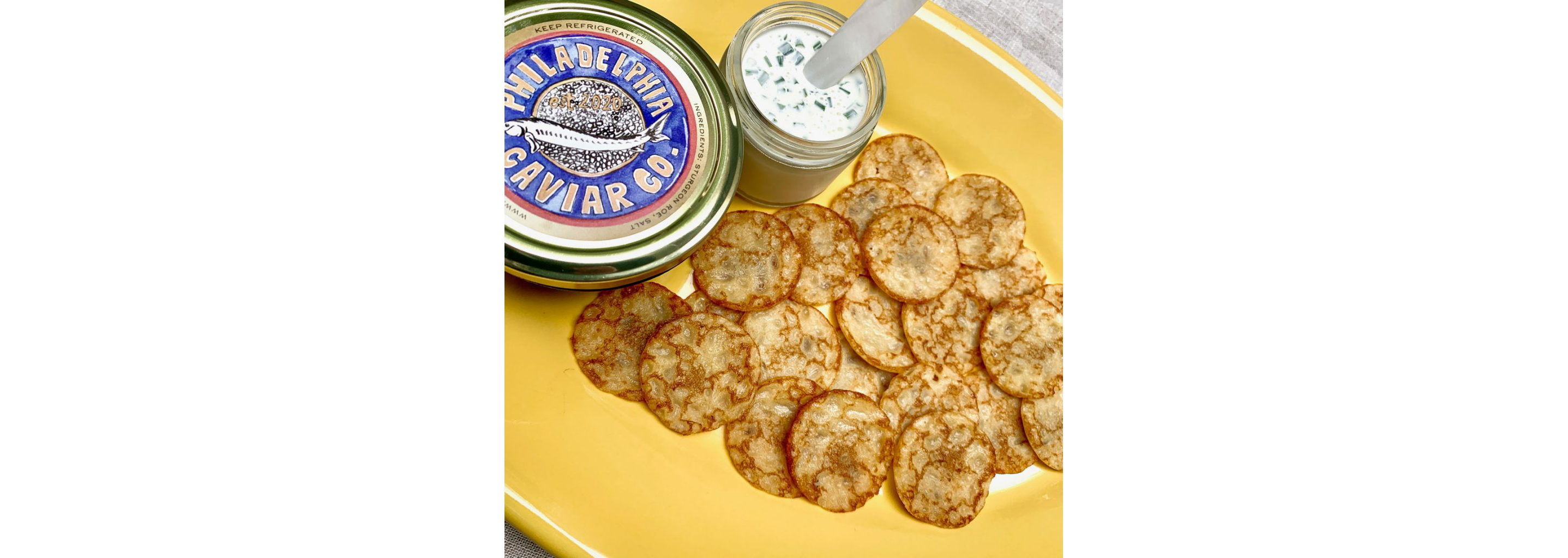 A large plate of freshly made blinis.