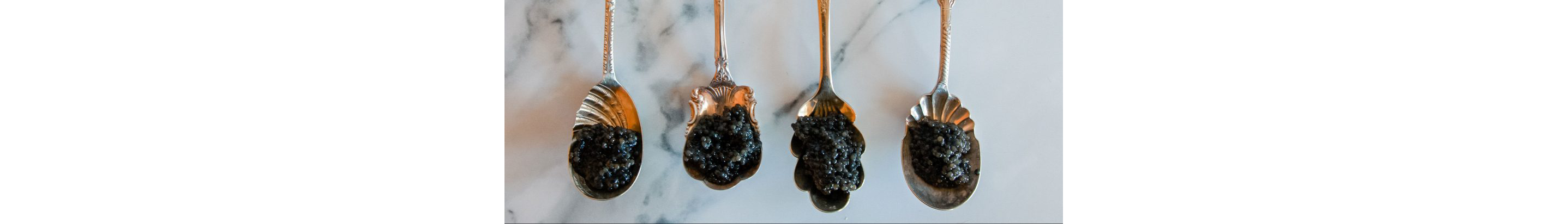 Ornate spoonfuls of black caviar.