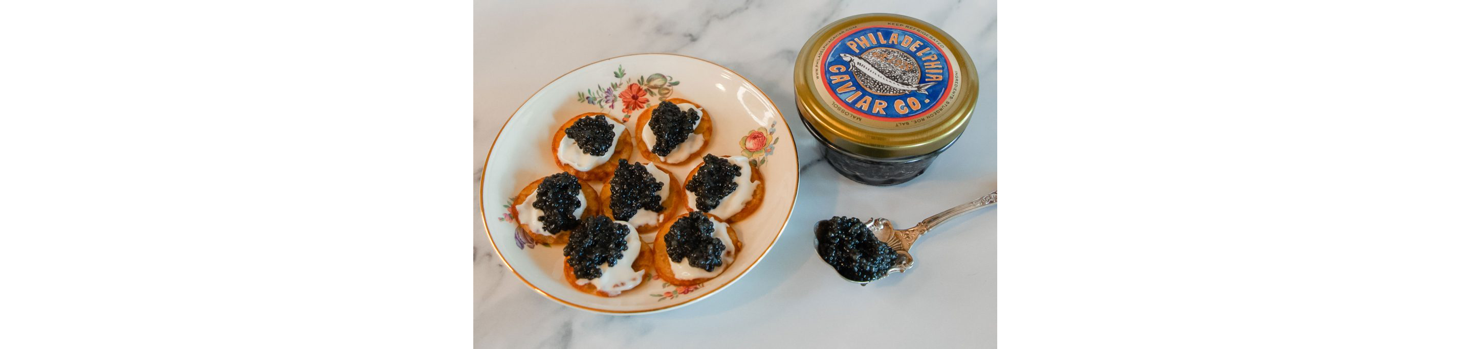 A plate of blinis topped with black caviar.