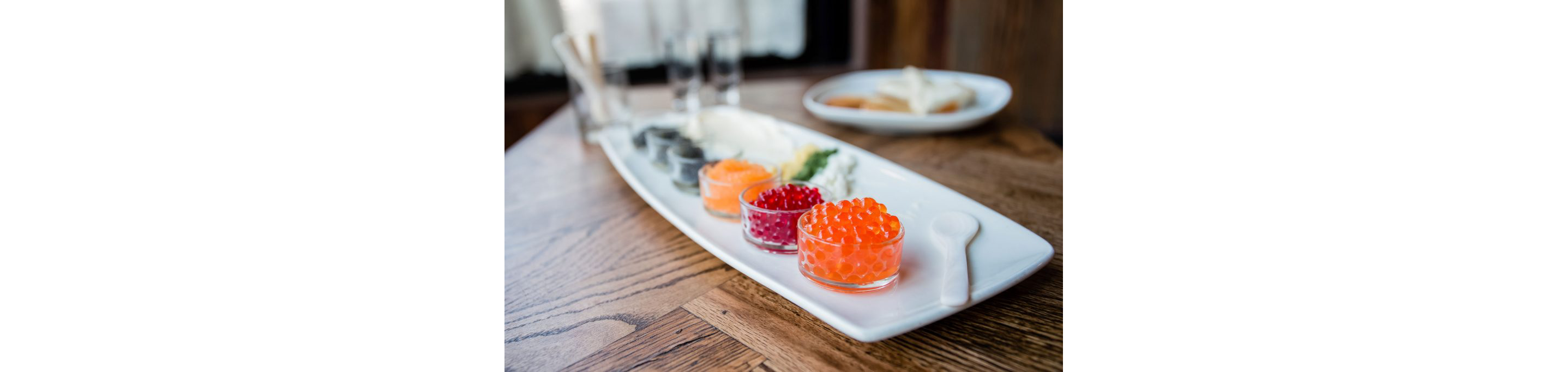 Colorful caviar in glass dishes.