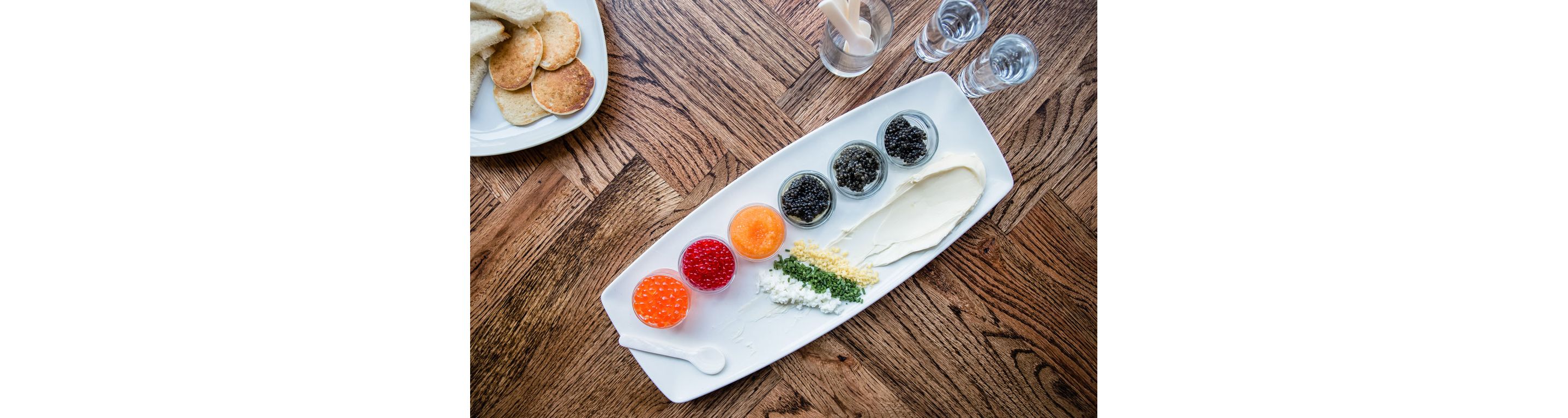 A variety of colorful caviar separated into individual glass dishes.