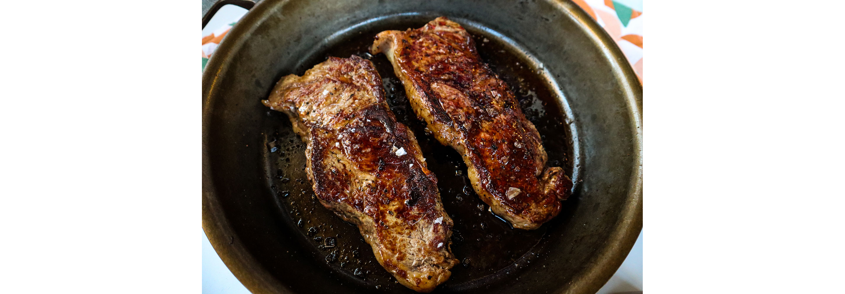 Two slabs of meat sprinkled with salt.