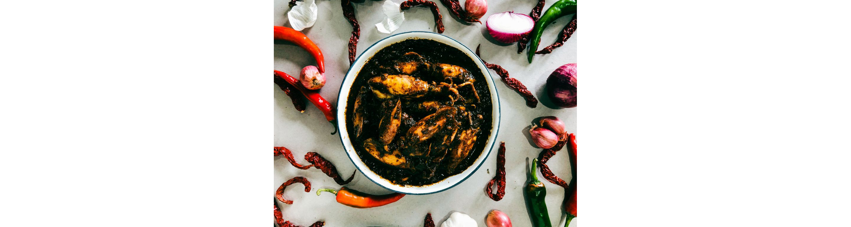 A bowl of sotong hitam, squid in squid ink.
