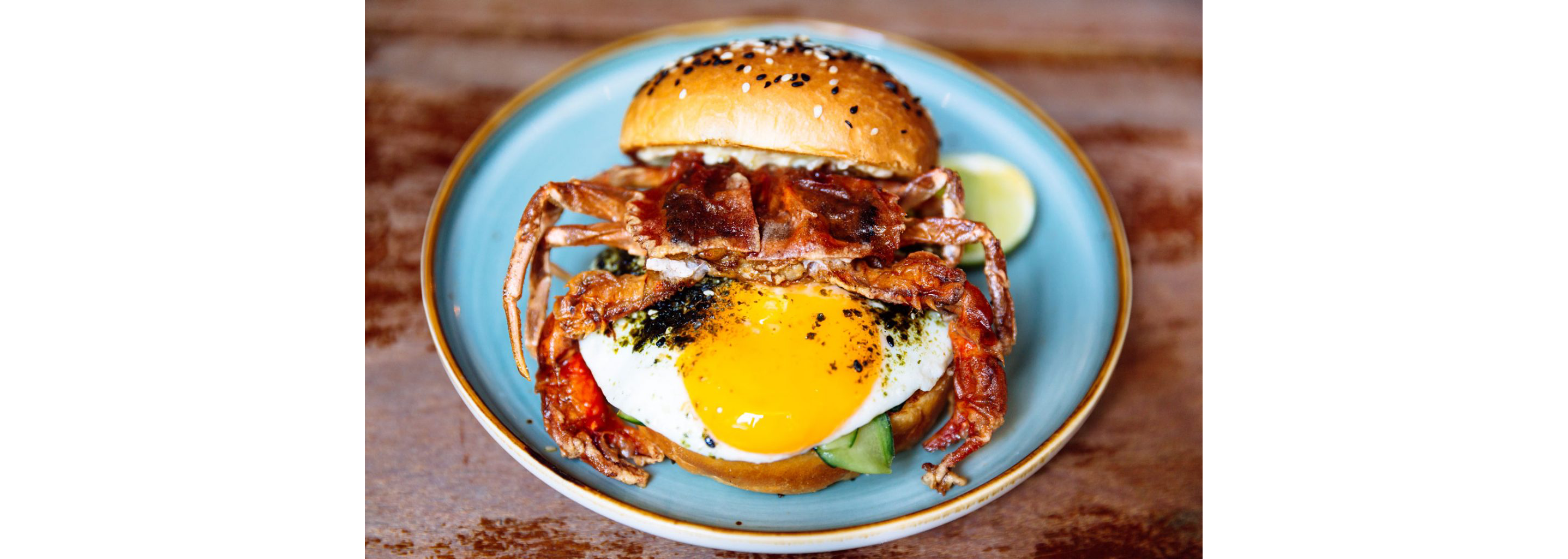 A delicious crab burger with a freshly fried egg.