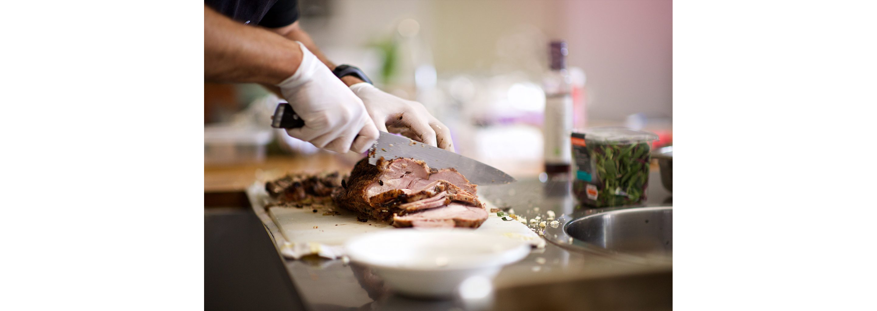 A person slicing the iconic beef pit known to Baltimore.