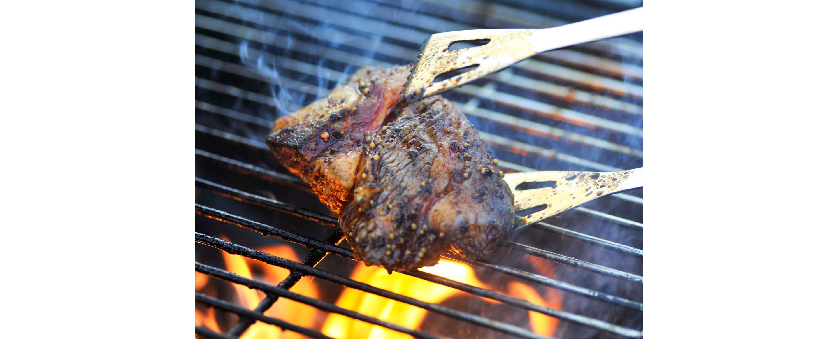 The iconic beef pit roasting on a charcoal grill.