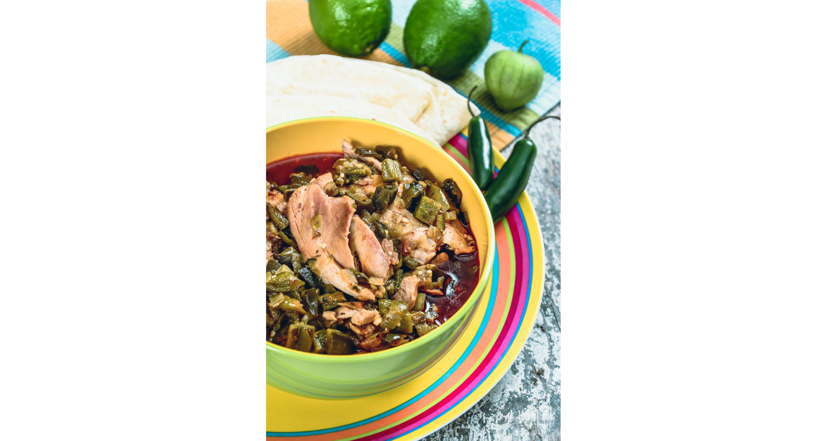 A colorful bowl of green chili made with pork.