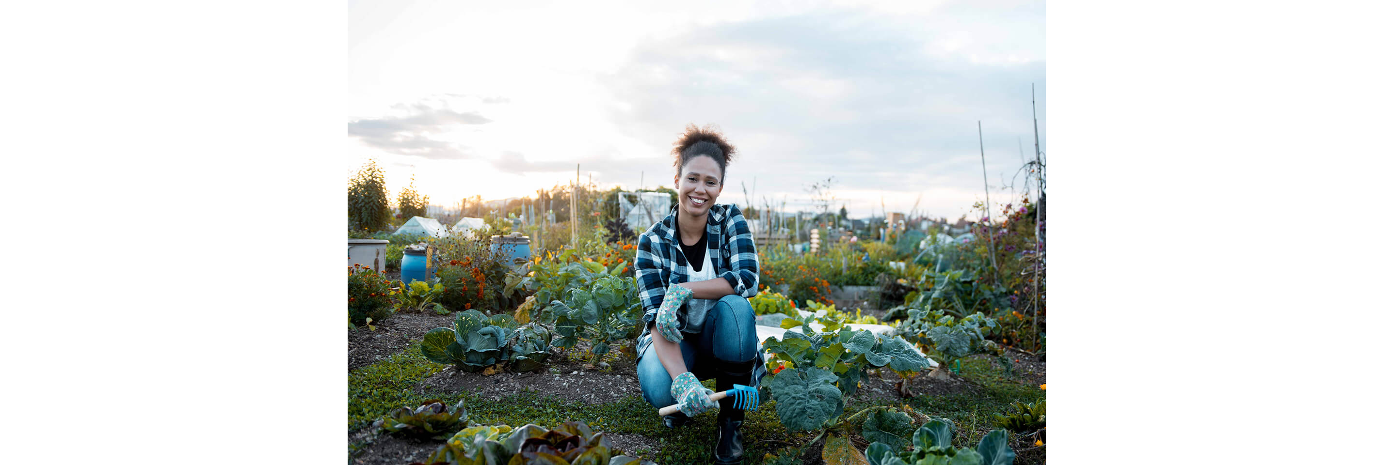 A young woman smiling for the camera in her gardening element.