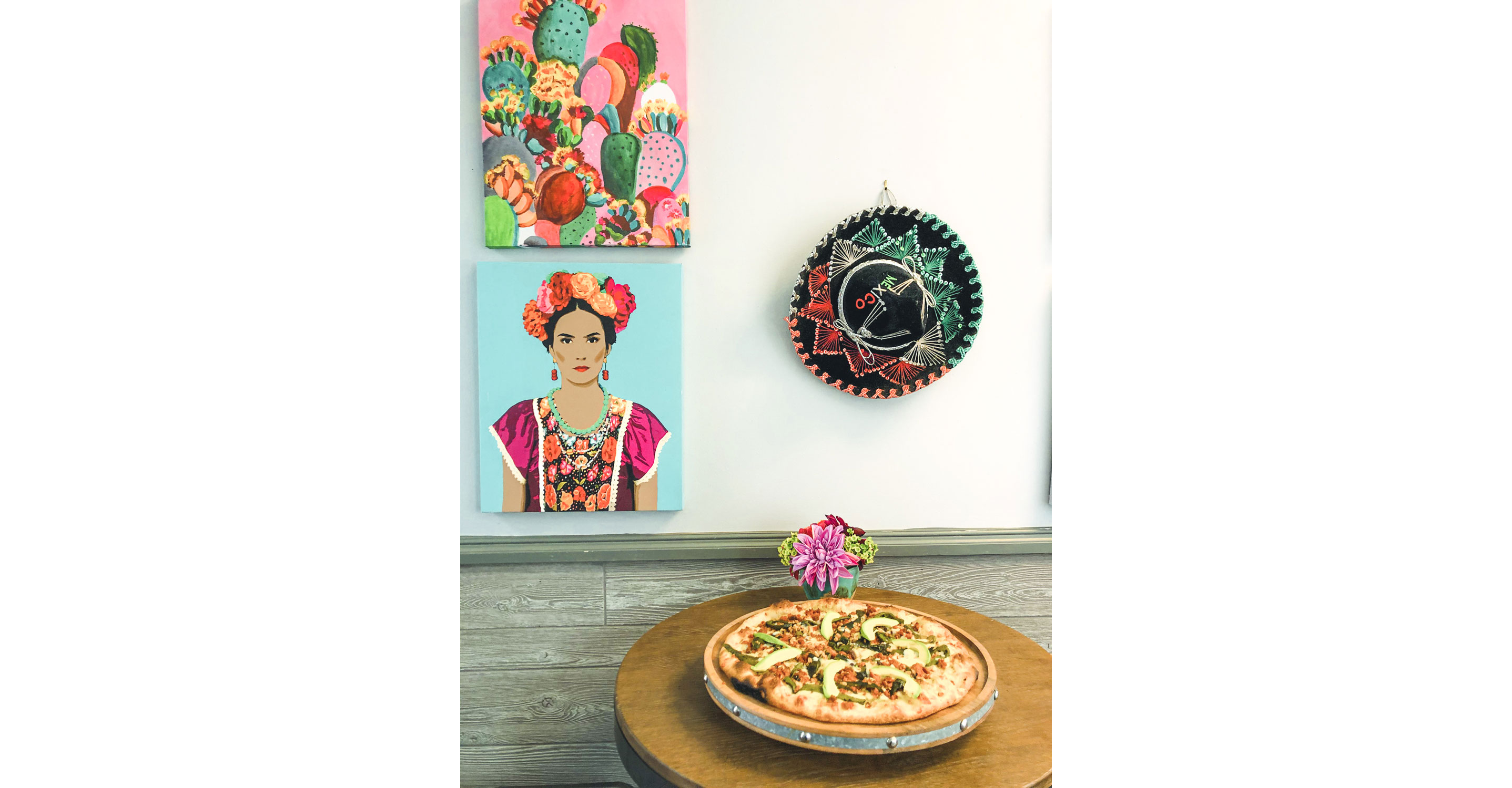 Mexican pizza accompanied by vibrant, colorful Mexican art.