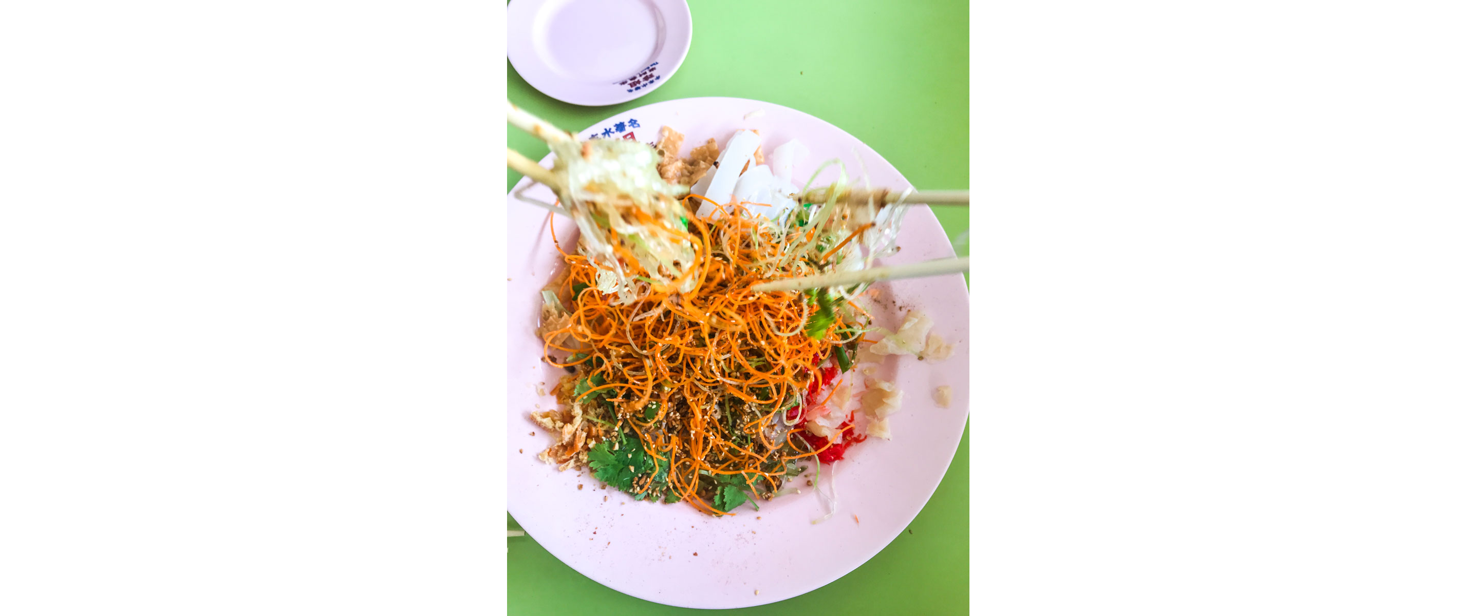 Mixing raw fish salad with chopsticks.