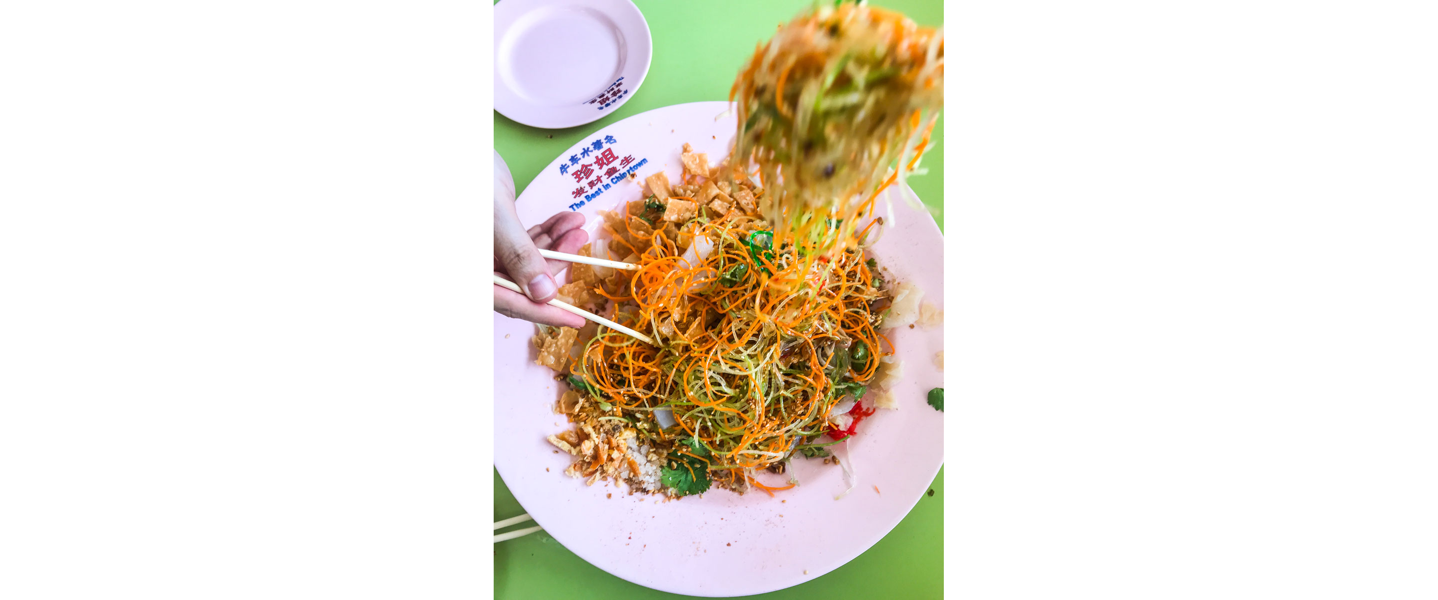 Adding ingredients to yusheng.