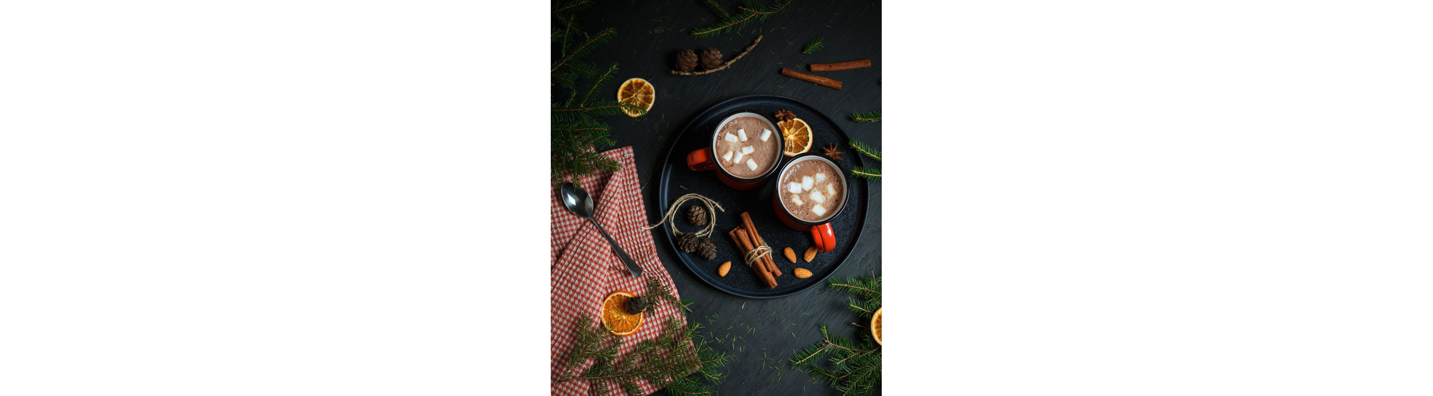 Two mugs of hot chocolate resting on a tray.