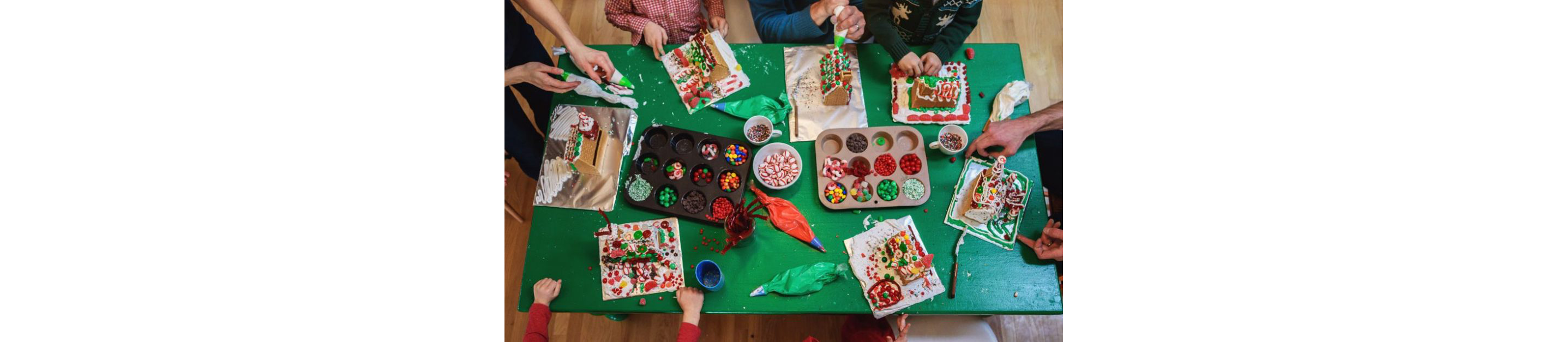 People decorating gingerbread houses.