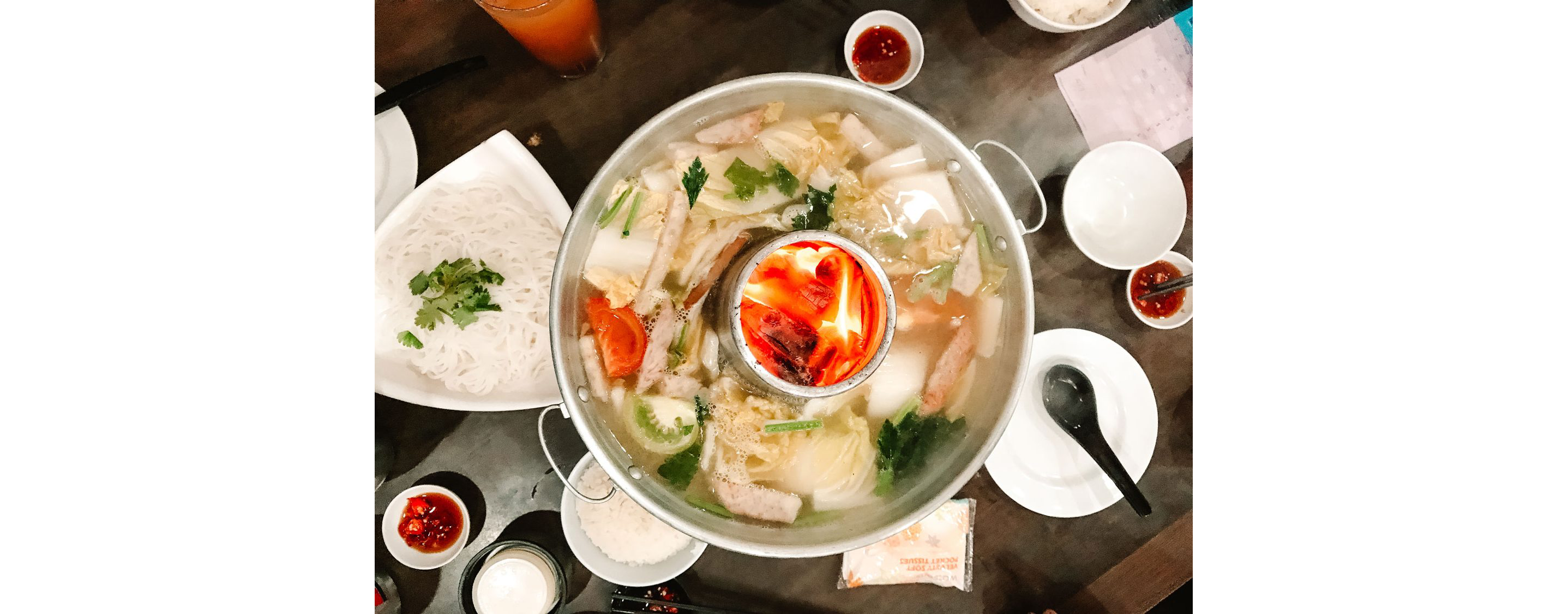 A large non-spicy steamboat in the center of the table.