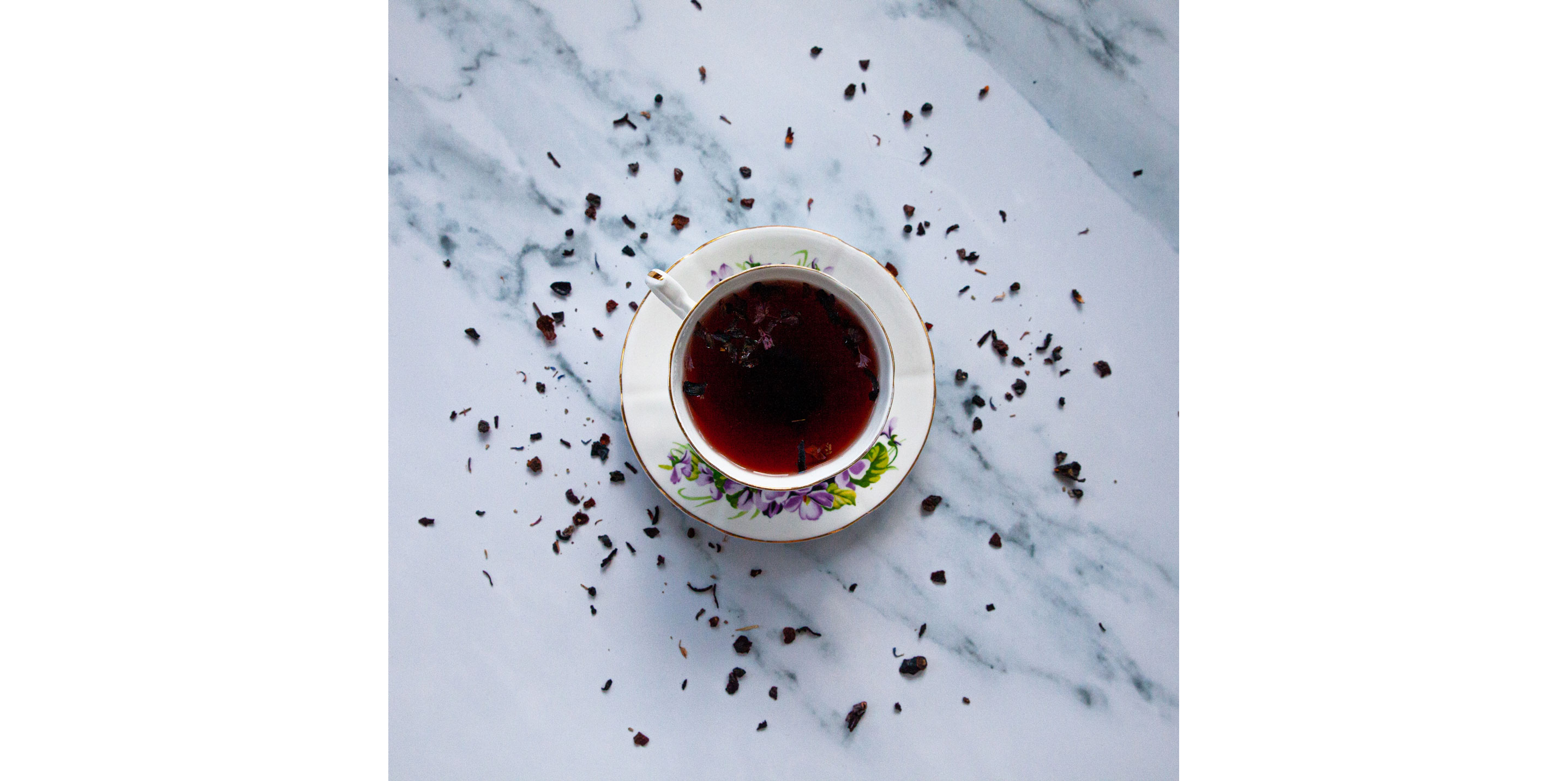 An elegant saucer and tea cup set filled with hot tea.