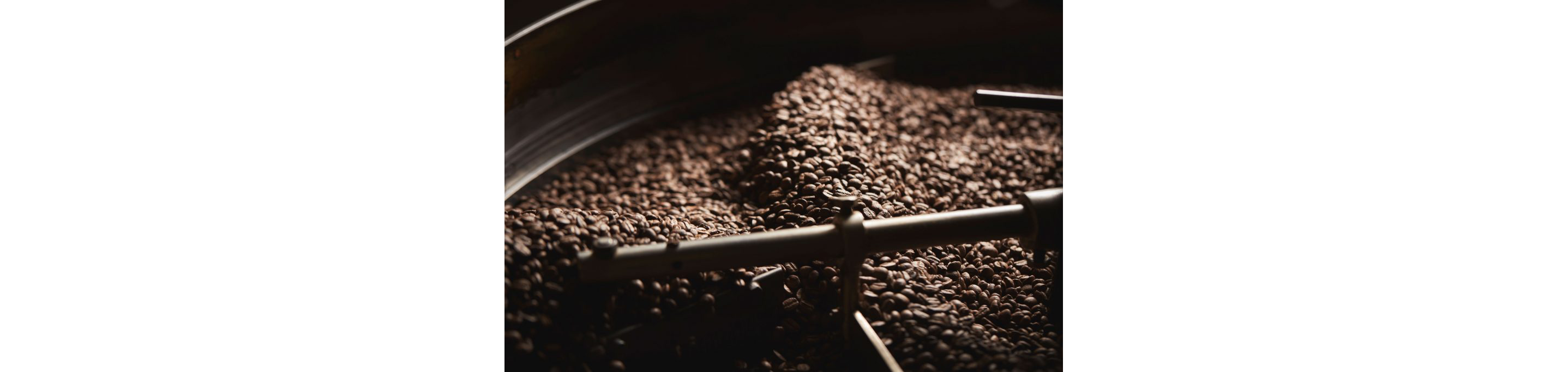 A coffee roaster cooling and mixing a batch of freshly roasted coffee beans.