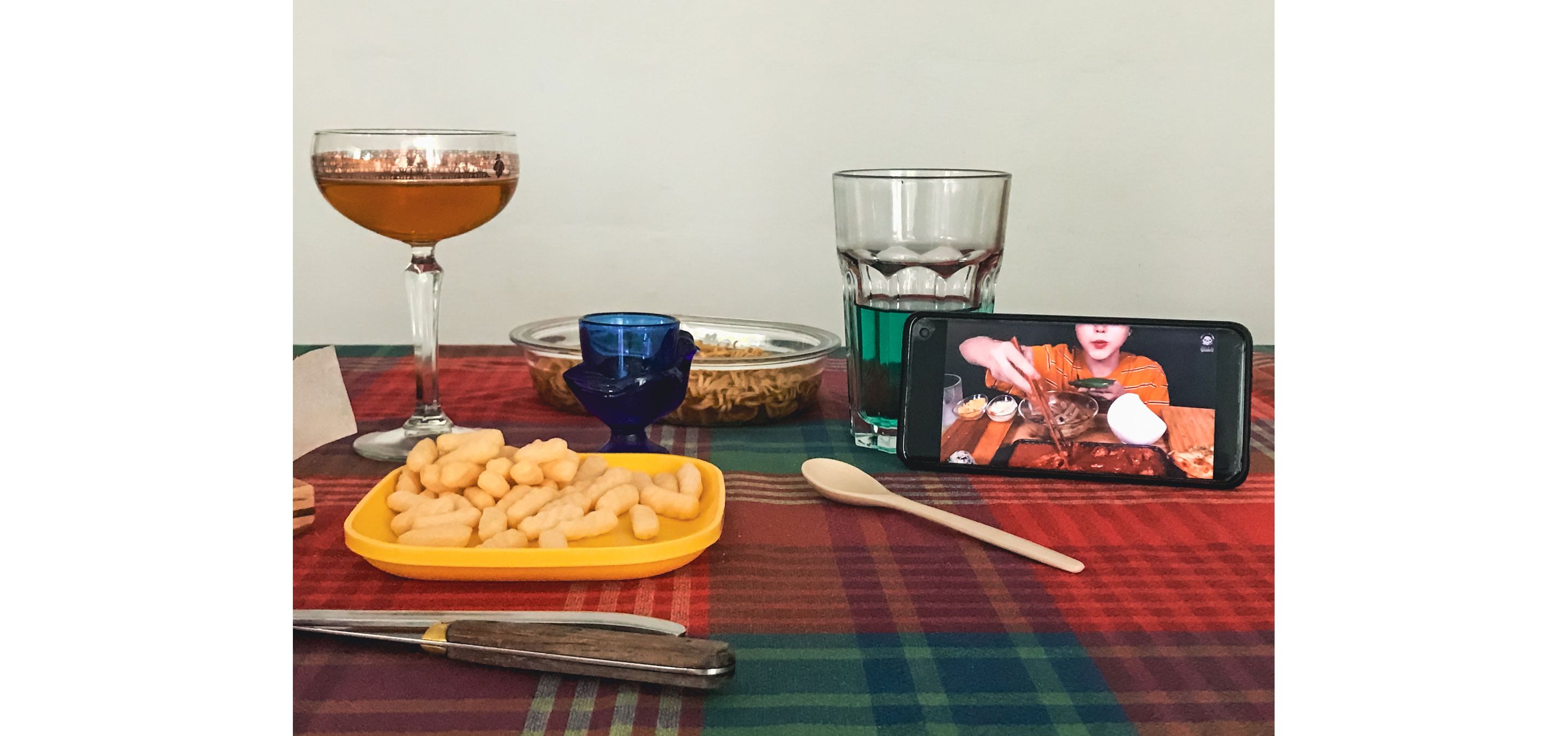 A table set for one with an open smart phone on the table.