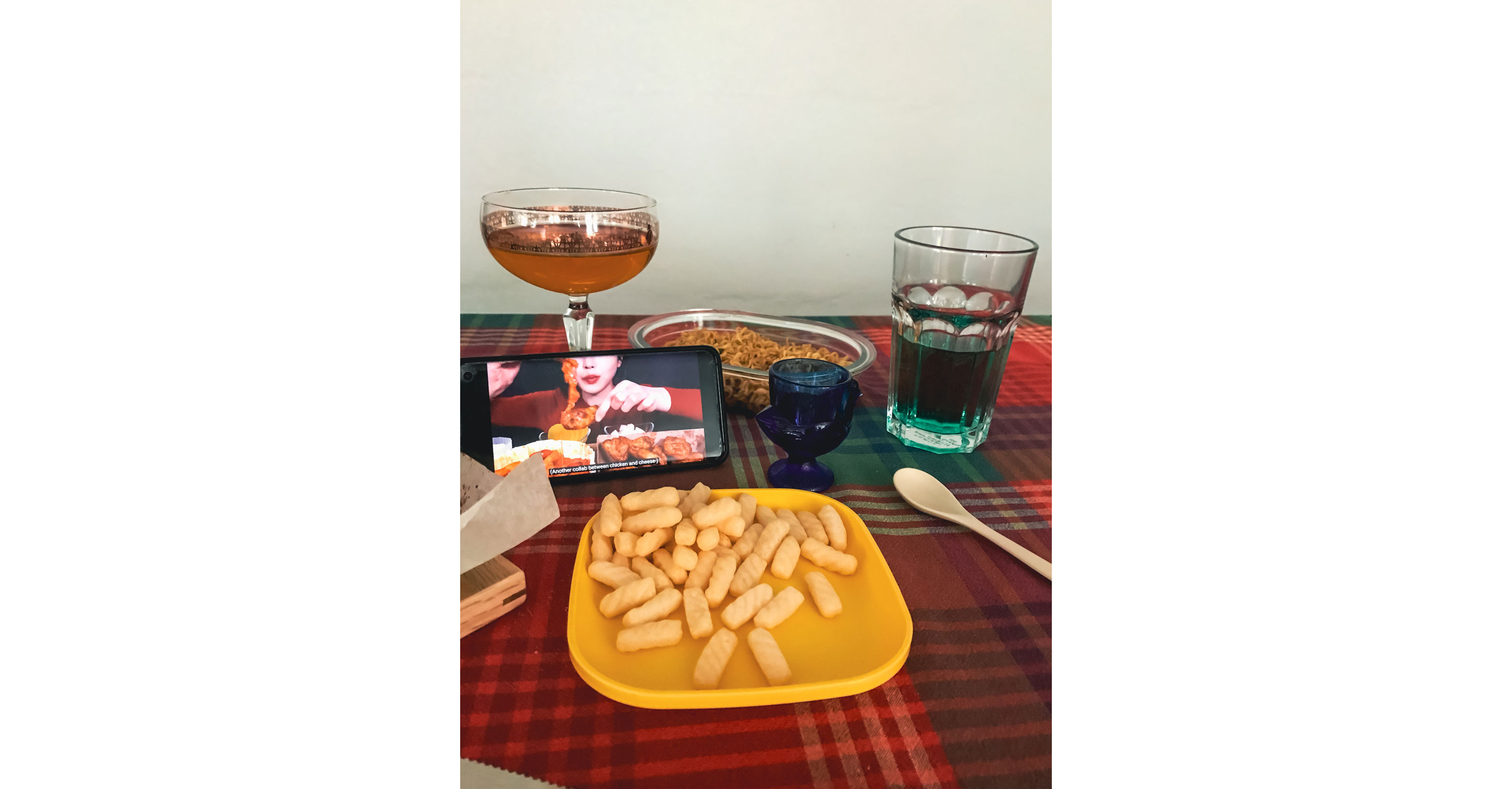 Food set out on a table with a smart phone open.