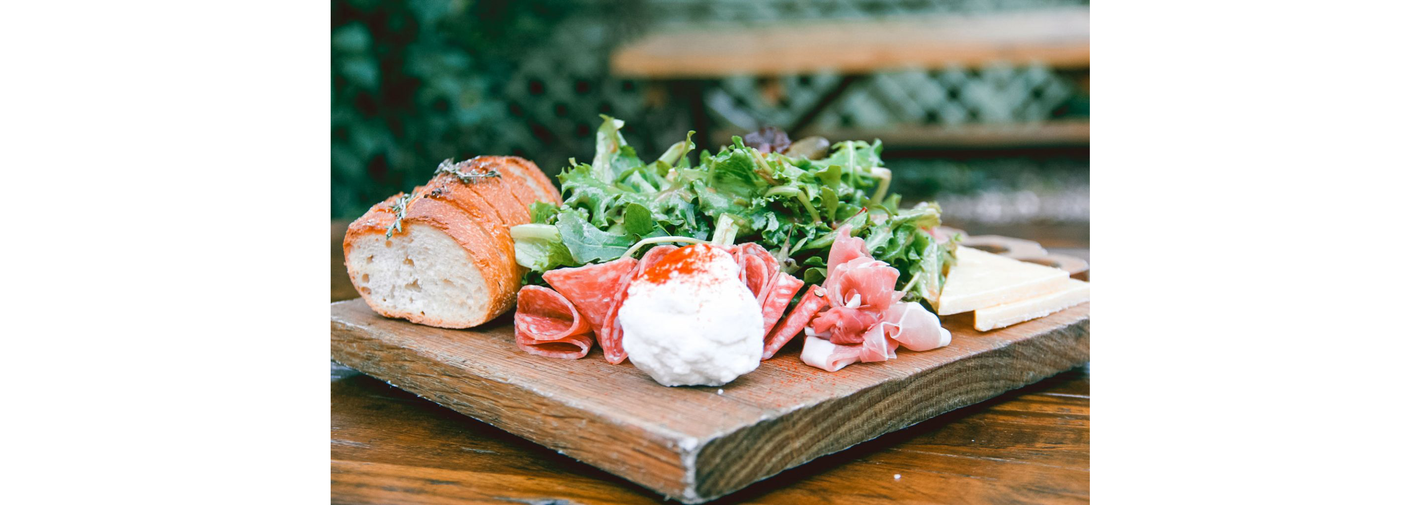 Close-up of salami and cheese board.
