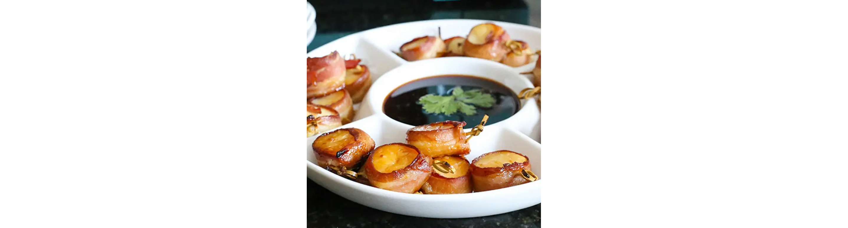 Bacon wrapped scallops on a serving tray