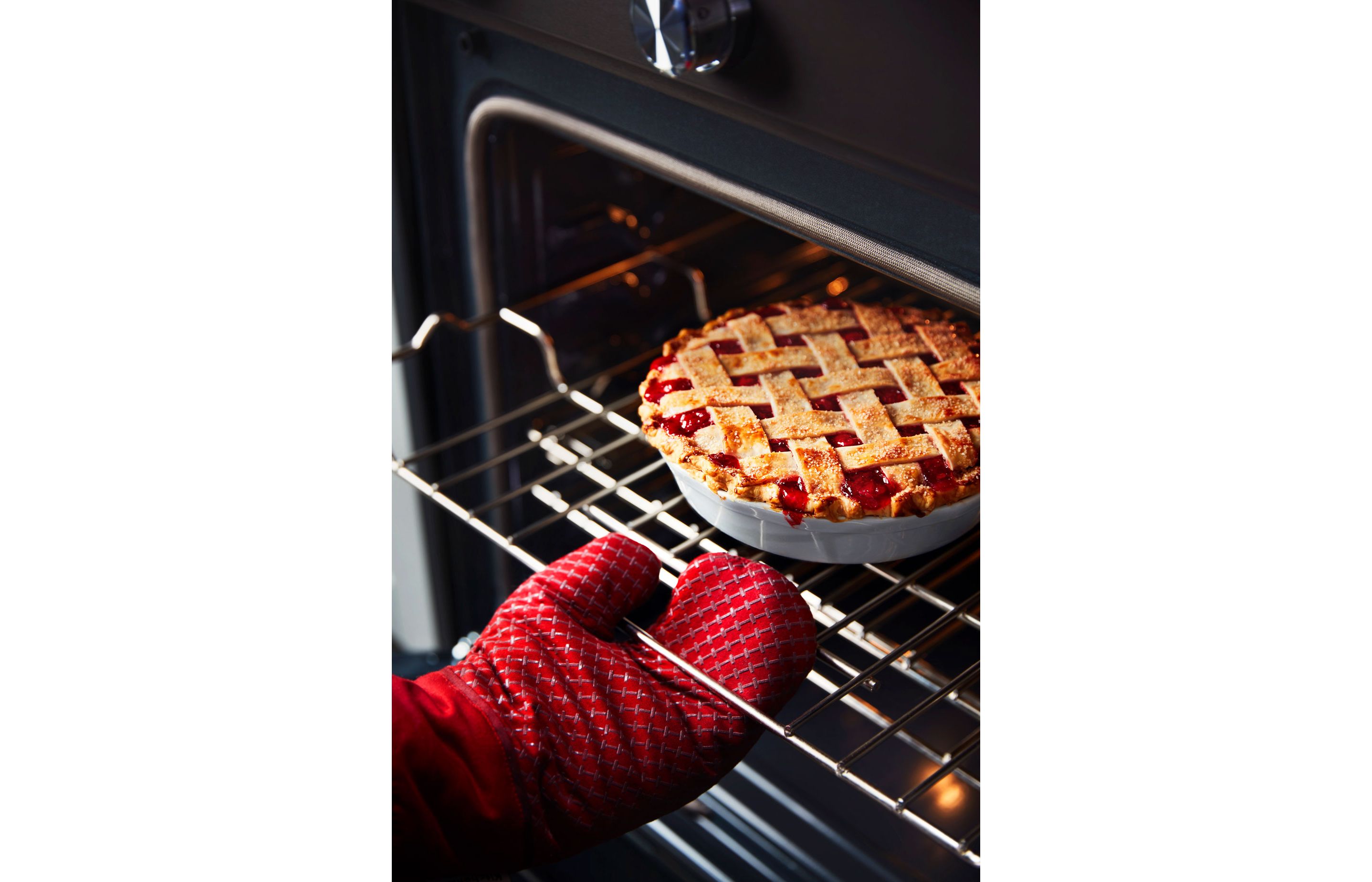 A fresh, flaky pie resting on an oven rack.