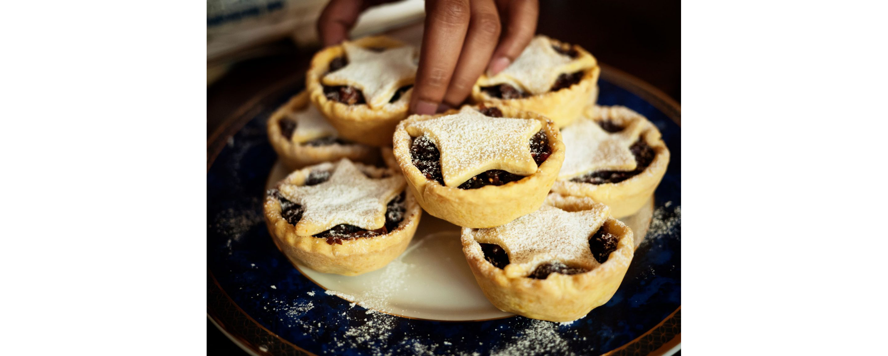 A dish filled with mini, starred mince pies.