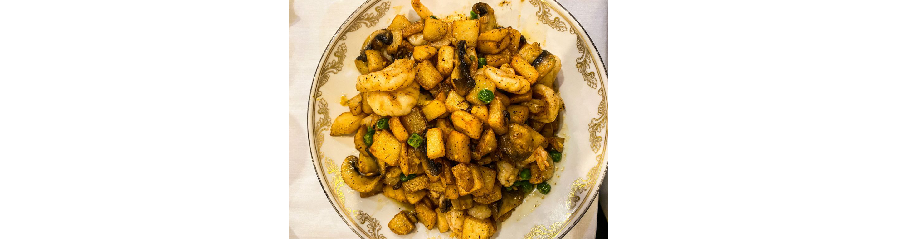 A delicious plate of potatoes, mushroom and shrimp.