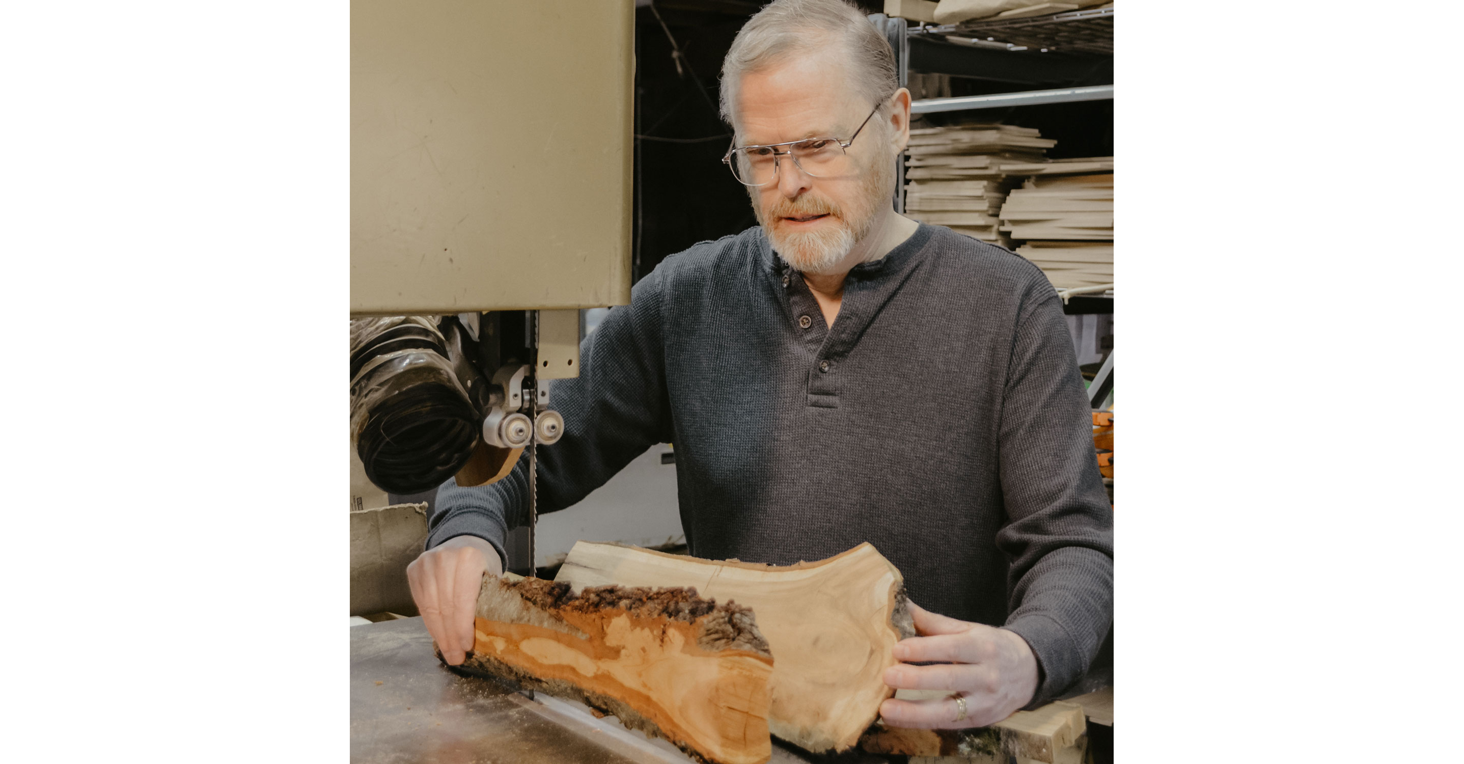 Jonathan Simons holding large pieces of wood.