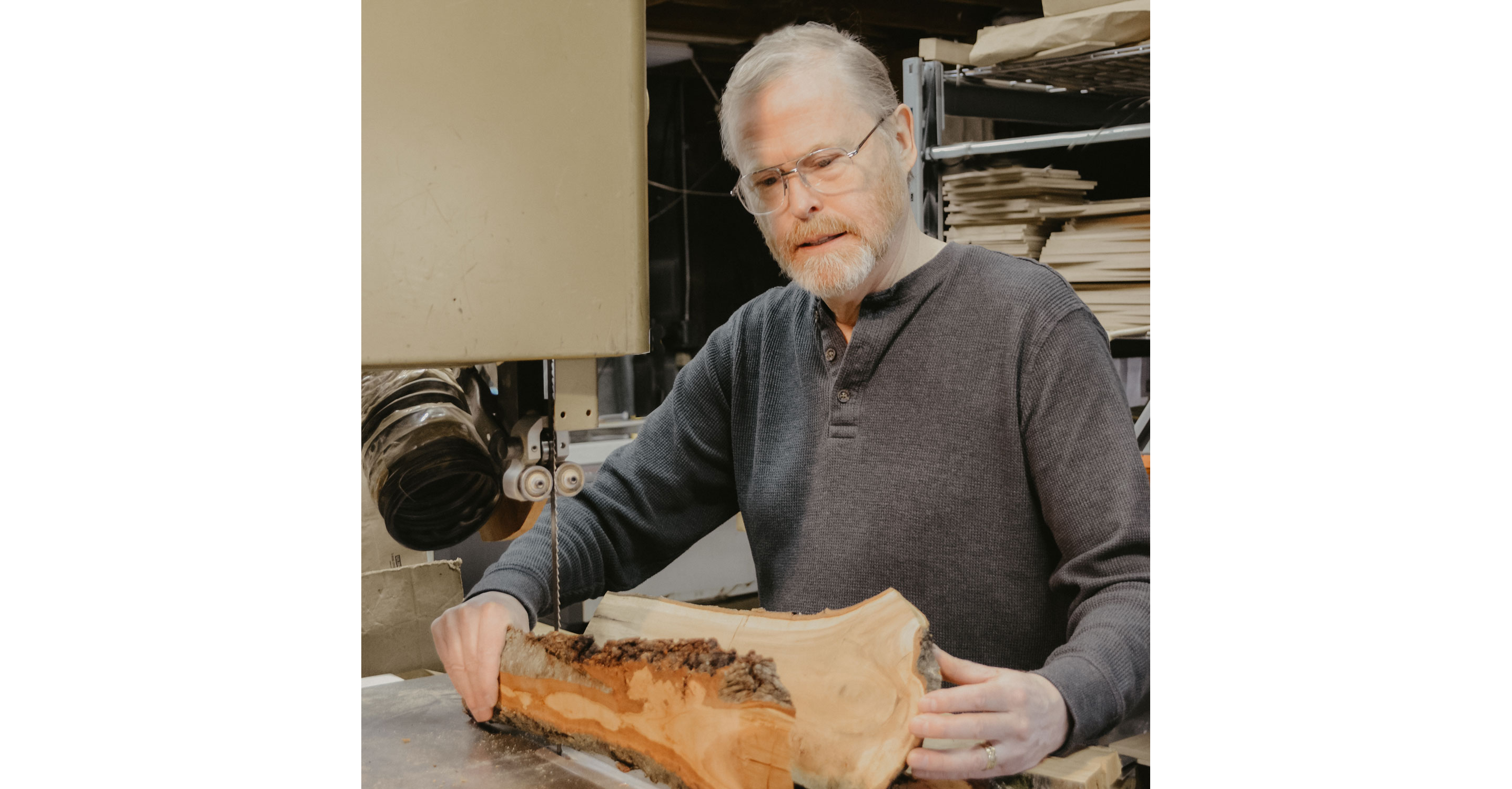 Jonathan Simons holding large pieces of wood.
