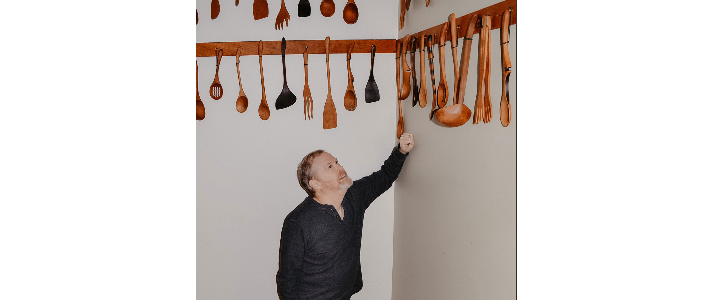 Jonathan Simons showing off his collection of wooden utensils.