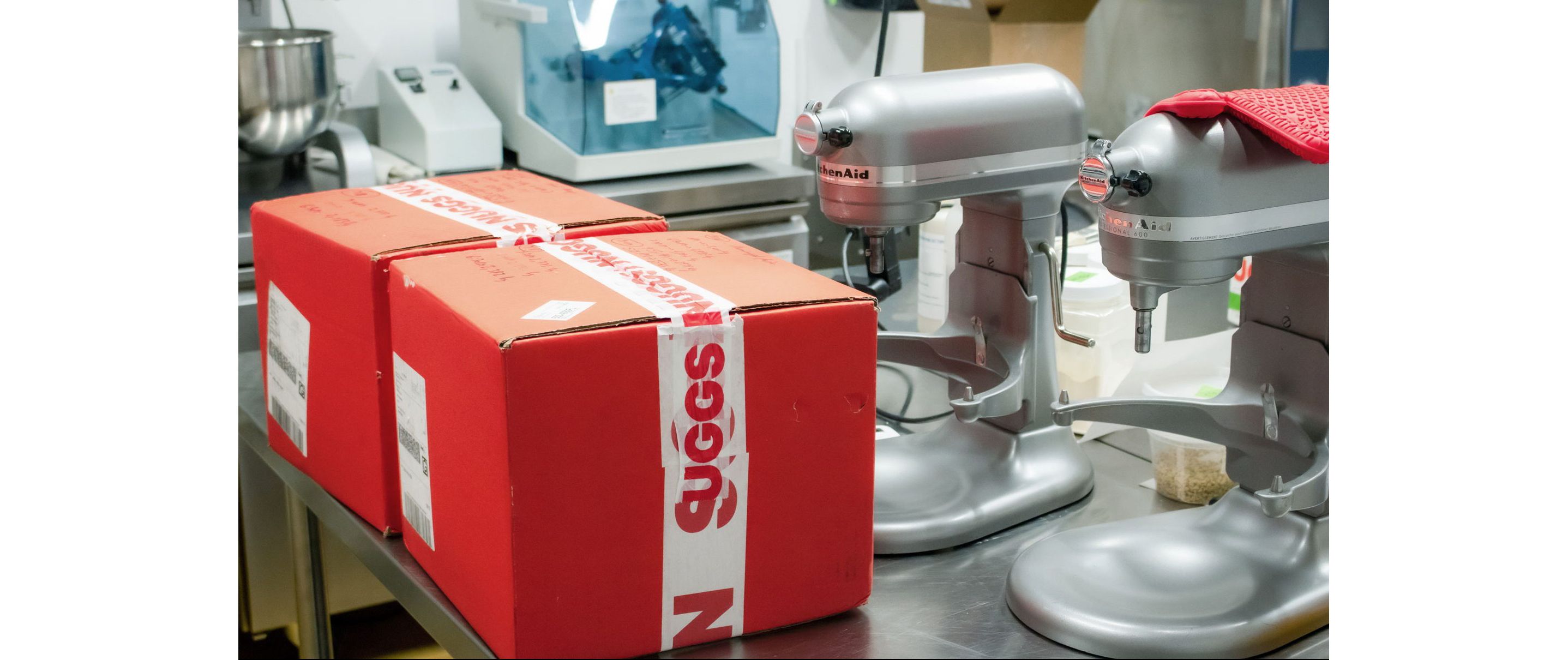 Two red Nuggs boxes tapped up and ready for shipping.