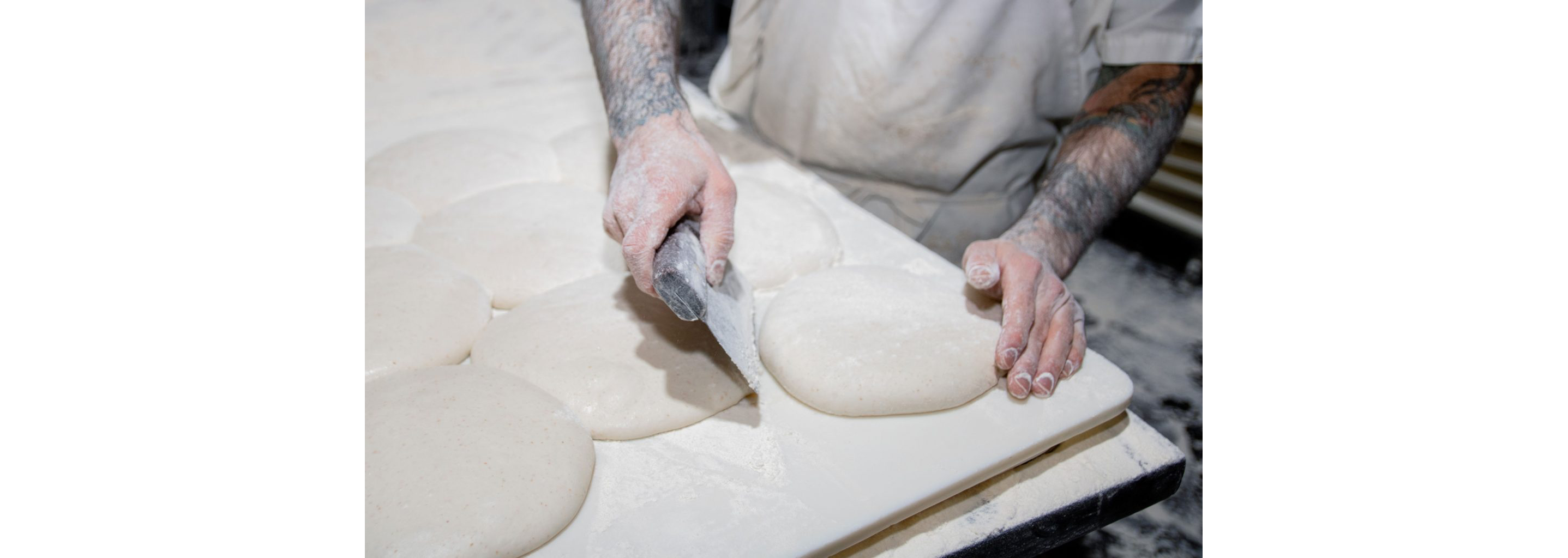 A person gently shaping dough.