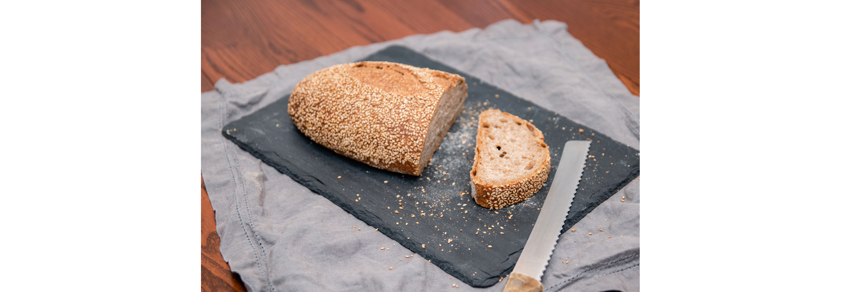 A loaf of bread with single slice cut off.