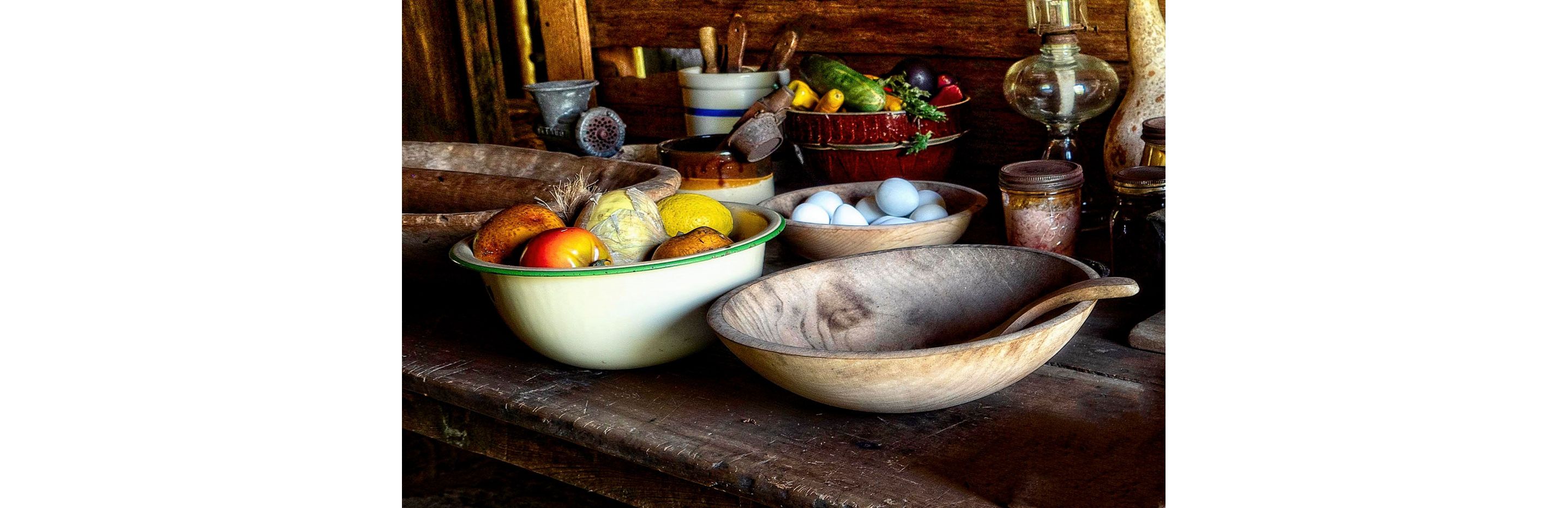 A variety of bowls filled with eggs, vegetables and other items.