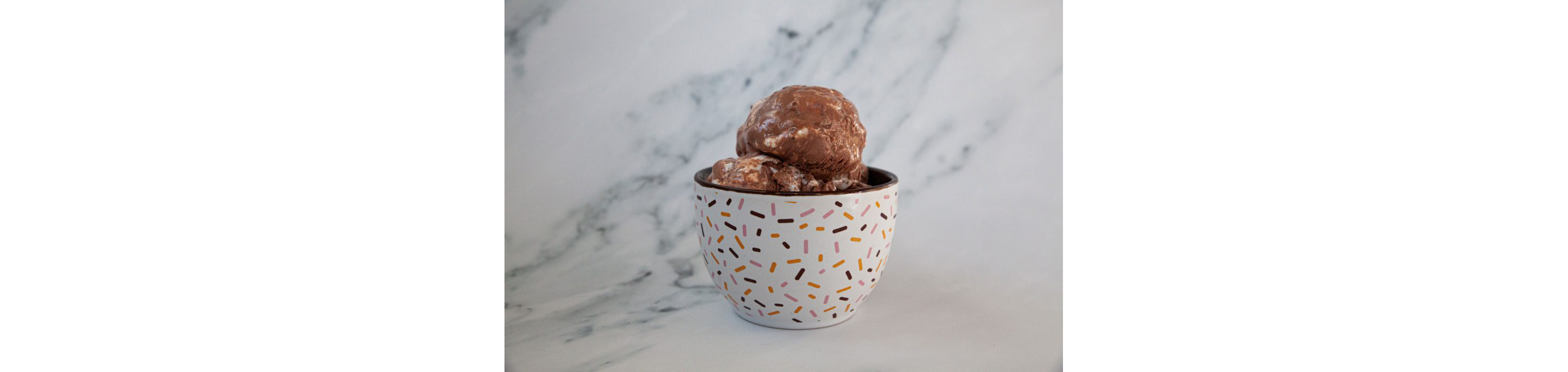 A delicate, coloful bowl filled with ice cream.