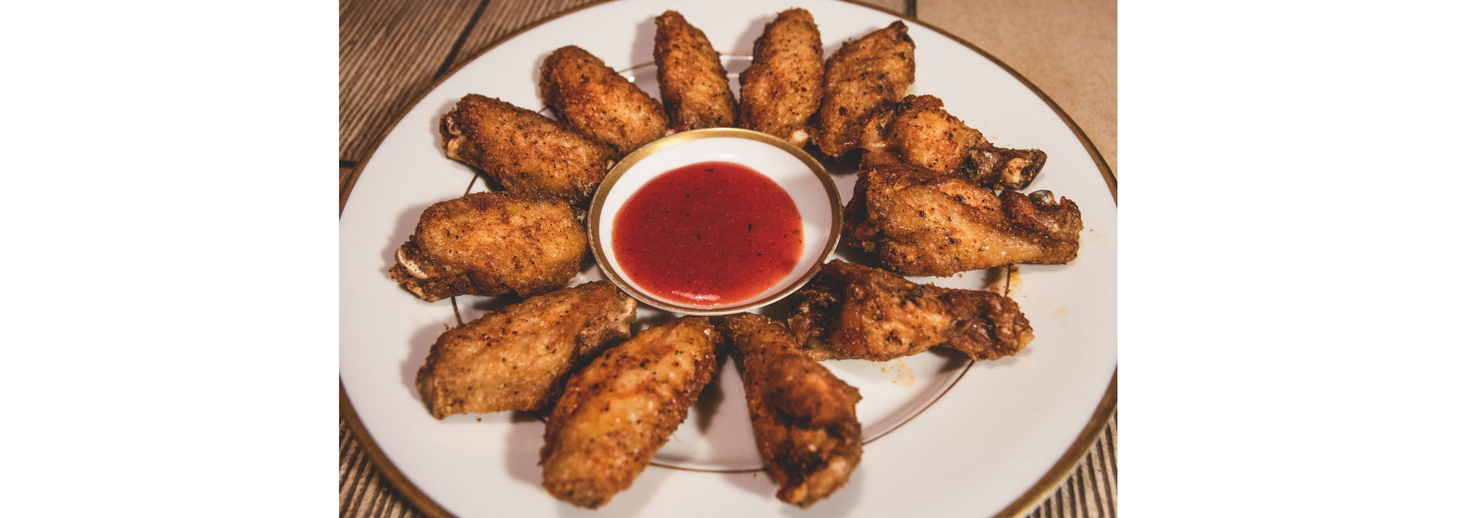 A plate of fried chicken legs and drums.